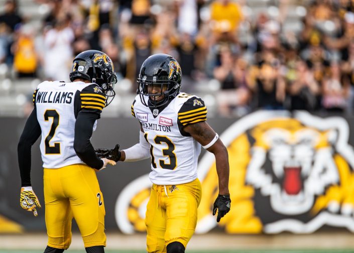 HAMILTON, ON – JUL. 28, 2018: Chris Williams and Jalen Saunders of the Hamilton Tiger-Cats celebrate a fourth quarter touchdown. HAMILTON, ON - JUL. 28, 2018: Chris Williams and Jalen Saunders of the Hamilton Tiger-Cats celebrate a fourth quarter touchdown.